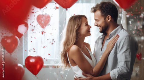 Couple is closely embracing and smiling at each other amidst a festive background