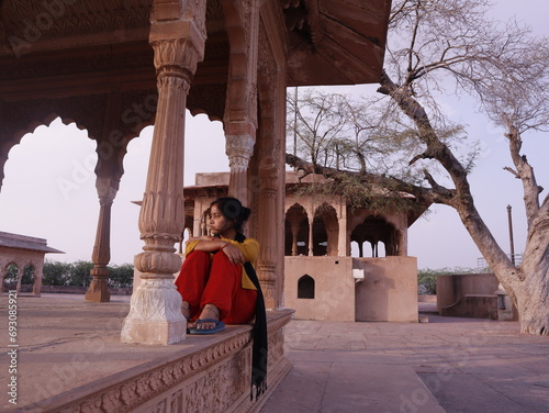 Sad girl sitting in heritage place named jawahar Burj in lohagarh fort of bharatpur rajasthan a tourist places of India , selective focus  photo
