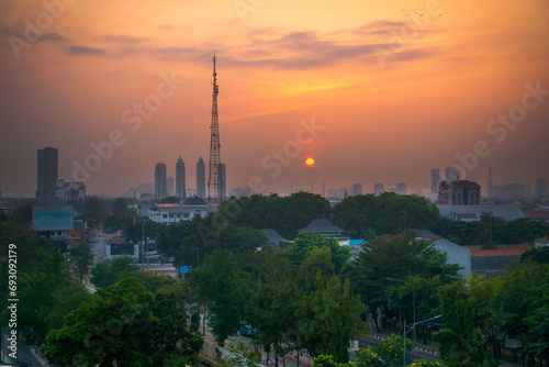 Indonesian morning view in the city of Jakarta during a beautiful morning with sunrise and tall buildings
