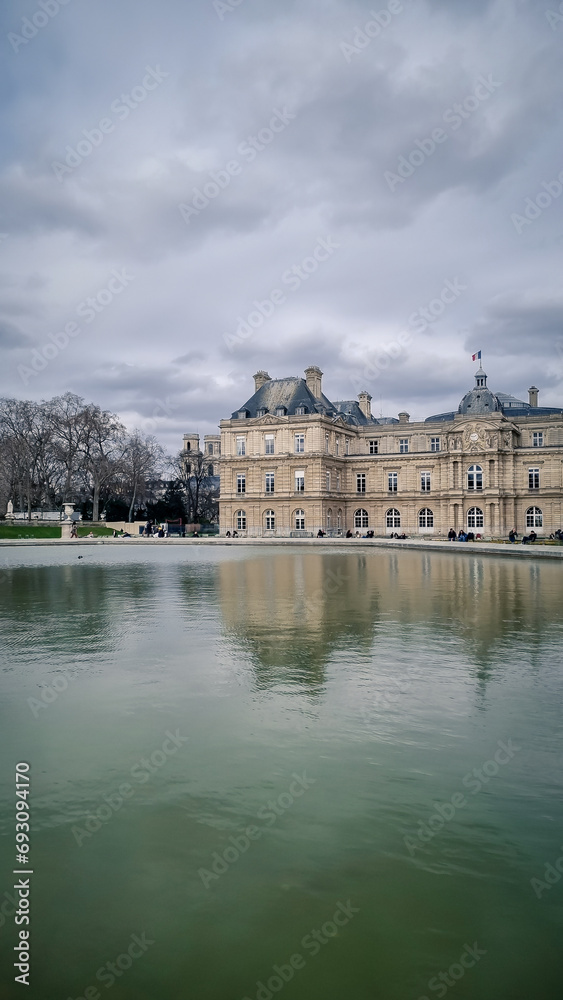 PARIS - March 11, 2023: Tourists relax in Luxembourg Gardens in Paris, France. Luxembourg area is popular among tourists in Paris, the most visited city worldwide.