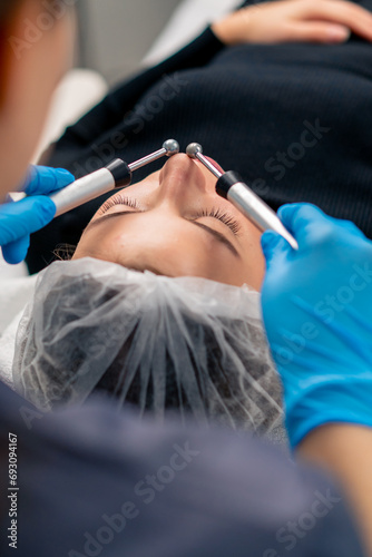 close-up of a beautician doctor massaging the skin of a client s face during a beauty and health cosmetic procedure