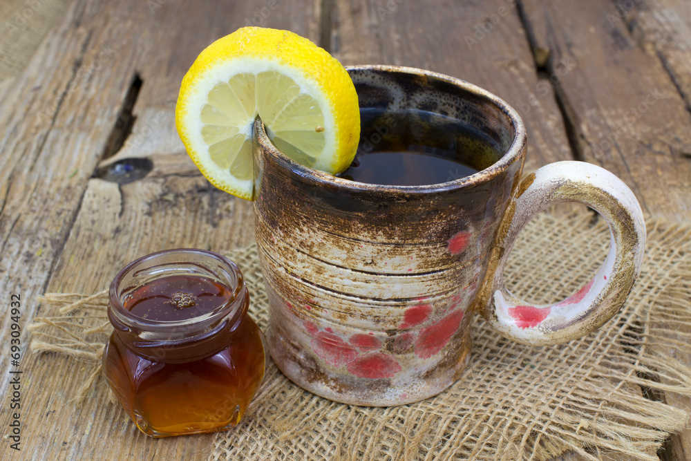 hot tea with lemon an honey on a wooden table hot tea with lemon an honey on a wooden table