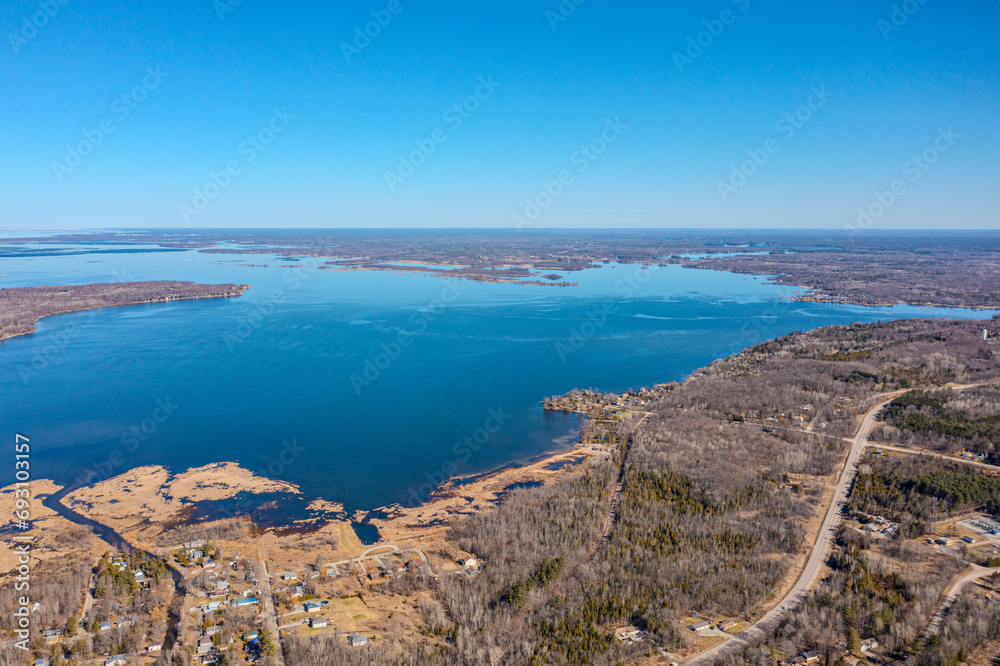 Expansive aerial views over Tay Township, Simcoe County, Ontario, capture the grandeur of the Canadian landscape. From the shimmering waters reflecting the sun's glare to the sprawling patches. Expansive aerial views over Tay Township, Simcoe County, Ontario, capture the grandeur of the Canadian landscape. From the shimmering waters reflecting the sun's glare to the sprawling patches.