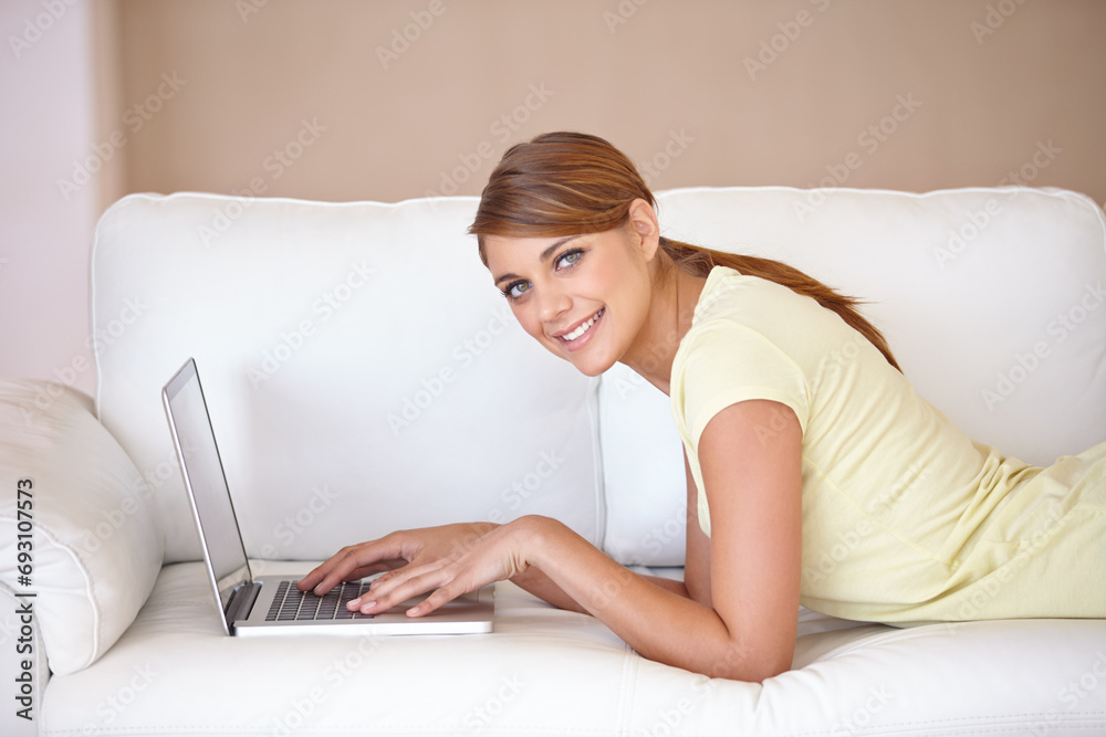 Woman, portrait and typing on laptop at sofa to update blog post, social media or digital subscription for remote work. Happy freelancer on computer for online shopping, email or relax in living room Woman, portrait and typing on laptop at sofa to update blog post, social media or digital subscription for remote work. Happy freelancer on computer for online shopping, email or relax in living room