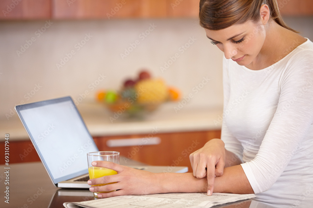 Woman, reading newspaper and kitchen with laptop, drinking orange juice and remote work at home. Computer, print media or freelancer check newsletter report for research, article information or story Woman, reading newspaper and kitchen with laptop, drinking orange juice and remote work at home. Computer, print media or freelancer check newsletter report for research, article information or story