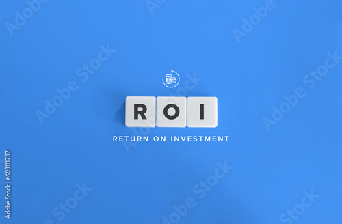 Return on Investment (ROI) or Return on Costs. Text on Block Letter Tiles and Icon on Flat Blue Background. Minimalist Aesthetics. photo