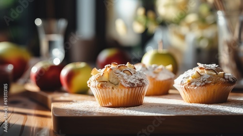 Homemade apple cinnamon muffins on defocused background, perfect dessert recipe with text space.