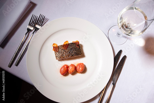 croaker fish with confit  tomatoes. Gourmet food presentation