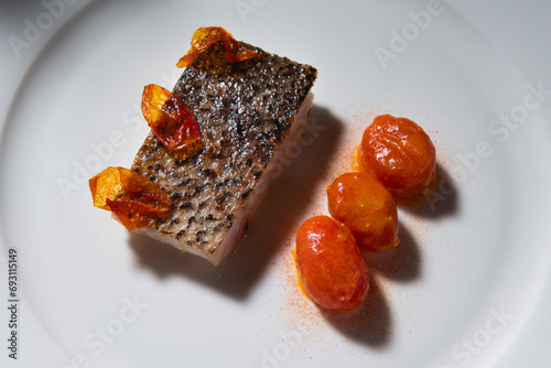 croaker fish with confit  tomatoes. Gourmet food presentation
