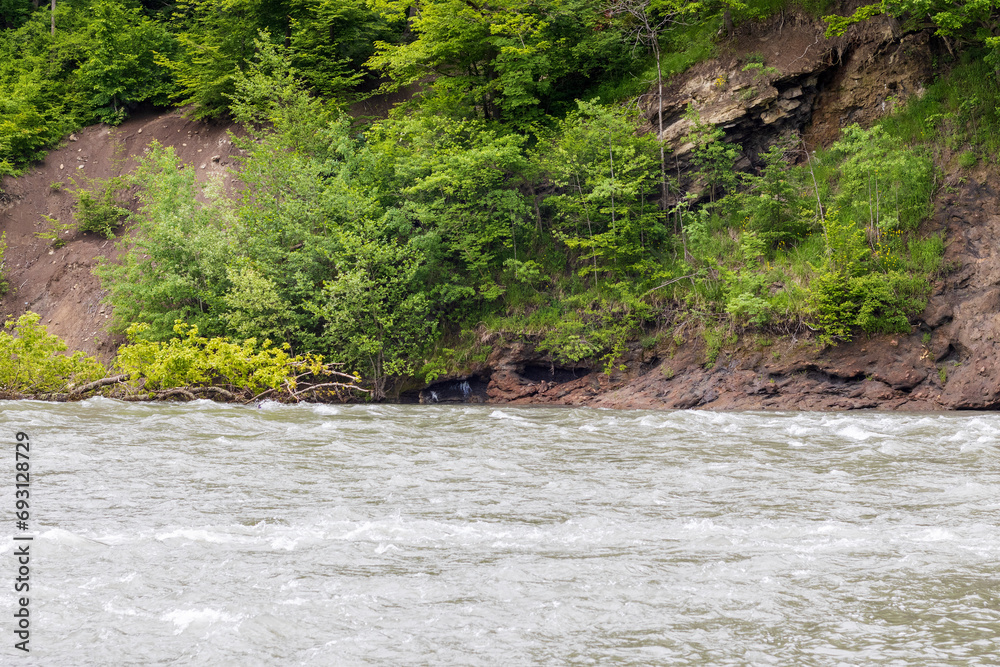 A full-flowing river, a mountainous area, a cloudy day, summer walks in the bosom of nature, a panorama of the area. A full-flowing river, a mountainous area, a cloudy day, summer walks in the bosom of nature, a panorama of the area.