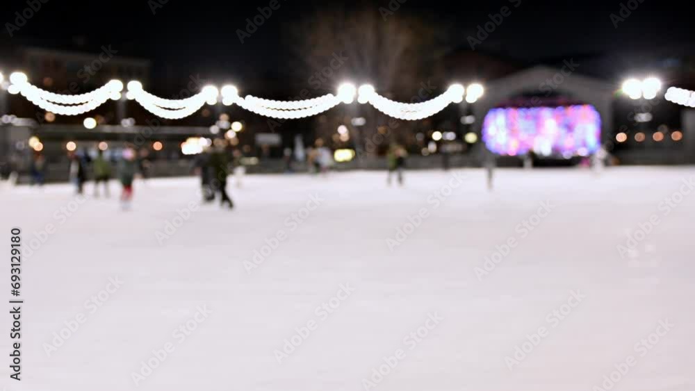 Selective focus . People spend their weekends skating. Ice skating is a