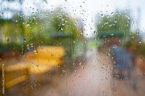 Blurred veranda background during Rain, Defocused photo through wet glass outdoor