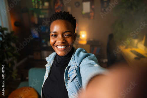 Happy friendly african woman internet teacher tutor looking at camera talking black dark skinned female online job interview at home portrait.