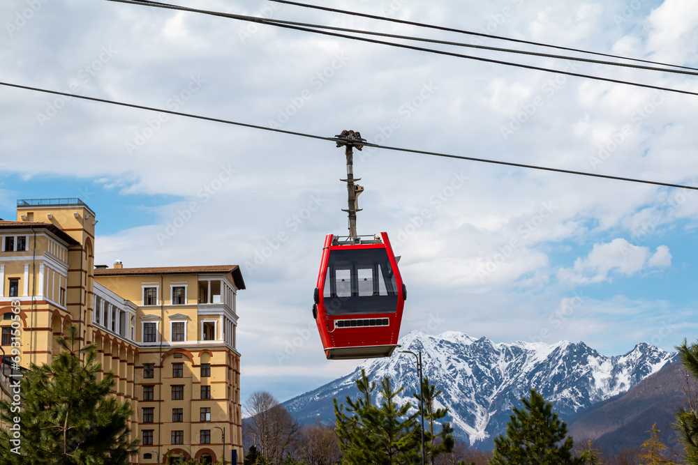 The cabin of the cable car against the backdrop of picturesque mountains covered with snow