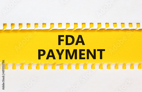 FDA Food and Drug Administration payment symbol. Concept words FDA payment on beautiful yellow paper. Beautiful white paper background. Business FDA payment concept. Copy space.