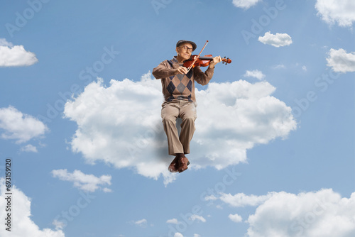 Elderly man floating on a cloud and playing a violin