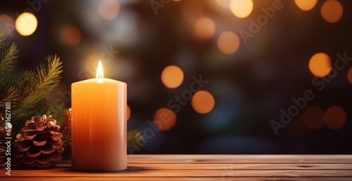 a candle hanging on a wooden table with greenery next to it