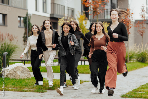 Group of many happy teenagers dressed in casual clothes having fun and having fun near college. Concept of friendship, moments of happiness. School friendship