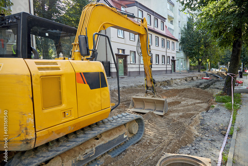 Road construction excavator on a construction site repairing a road in the city