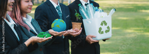 Group of businesspeople volunteer to promote Earth Day and environmental friendly, embracing ESG or Environmental, Social, and Governance practice to contribute greener environment sustainability.Gyre