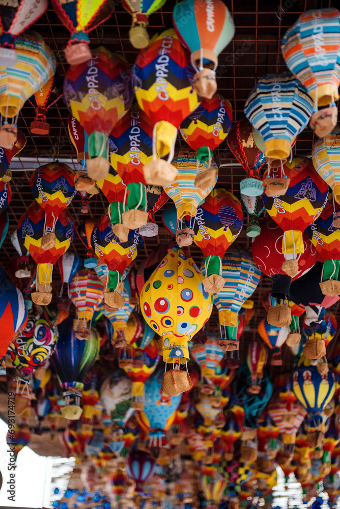 Different colorful souvenirs of air balloons hanging in street market. Handmade decoration and reminders for travellers in Turkey. Symbolic meaning of Cappadocia. Different colorful souvenirs of air balloons hanging in street market. Handmade decoration and reminders for travellers in Turkey. Symbolic meaning of Cappadocia.