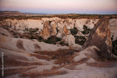 Amazing sunset view with tuff rock formation in Turkey, Cappadocia. Beautiful desert and valley during summer time.