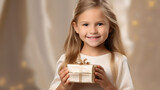 Little child cute girl  holding wrapped gift box in hands. Holiday event celebration