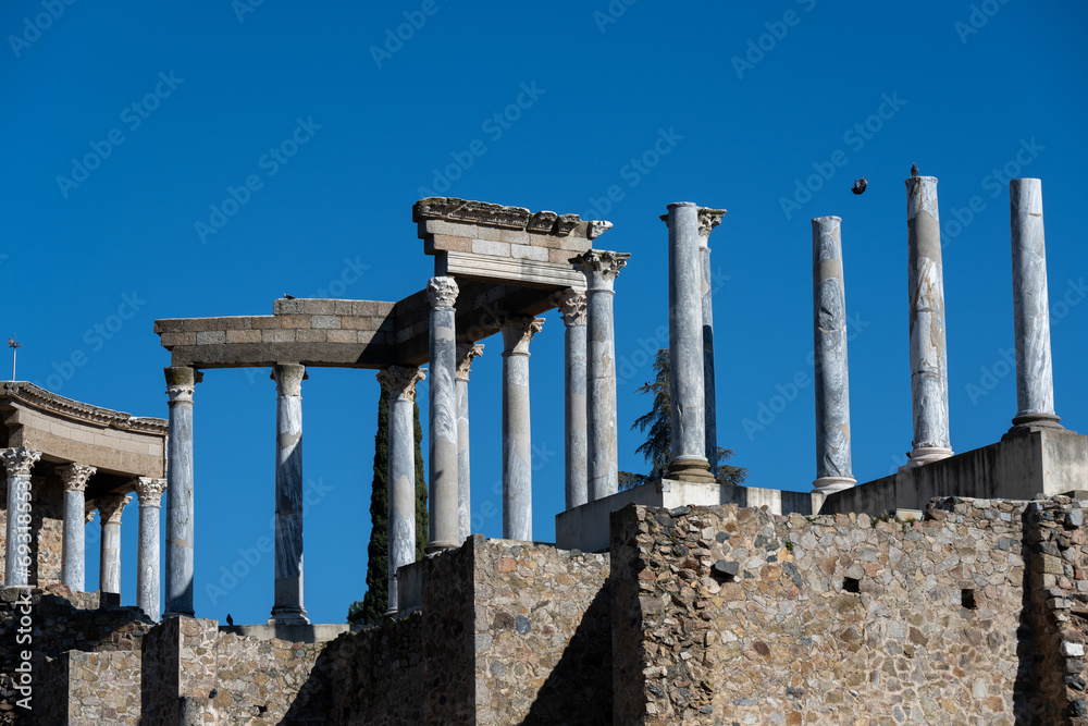 Fototapeta premium Panoramic view of the ancient Roman theater ruins of Merida, Spain under clear blue sky.