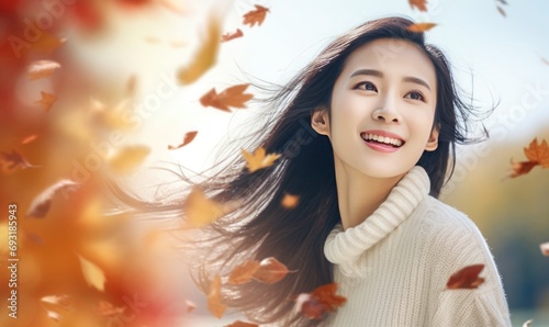 Autumn Bliss: Capturing the Radiance of a Happy Mature Asian Woman in a White Knitted Sweater Amidst Falling Leaves, High-Key Close-Up © hisilly