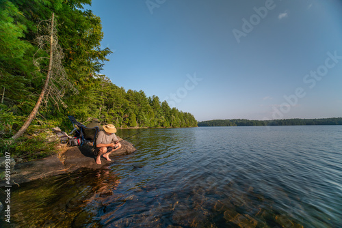 Family hobby, fishing at lake during summer. Throwing fish line reel in the water, fly fishing. Family day vacation at wilderness. Wife and husband alone together have relaxing leisure photo