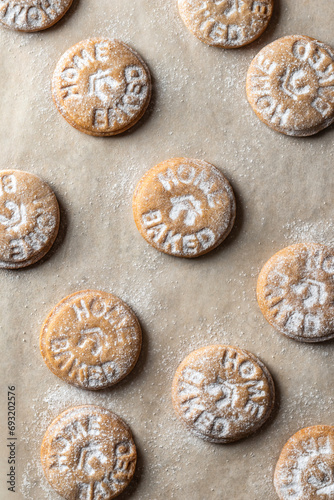 Homemade gingerbread cookies on parchment background Top view. Christmas traditional desserts concept, pattern © Hanna