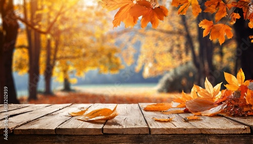 wooden table with orange leaves autumn background