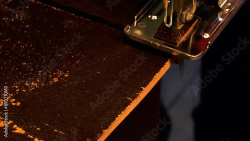 Jigsaw cuts a board. Slow motion. Electric jigsaw cuts a wooden slab. A piece of furniture is cut with a saw in a carpentry workshop. Furniture in factory. Carpenter works with wood. Professional tool