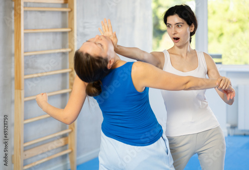 During their self-defense class  women trained in executing powerful palm punch aimed at attacker s head.