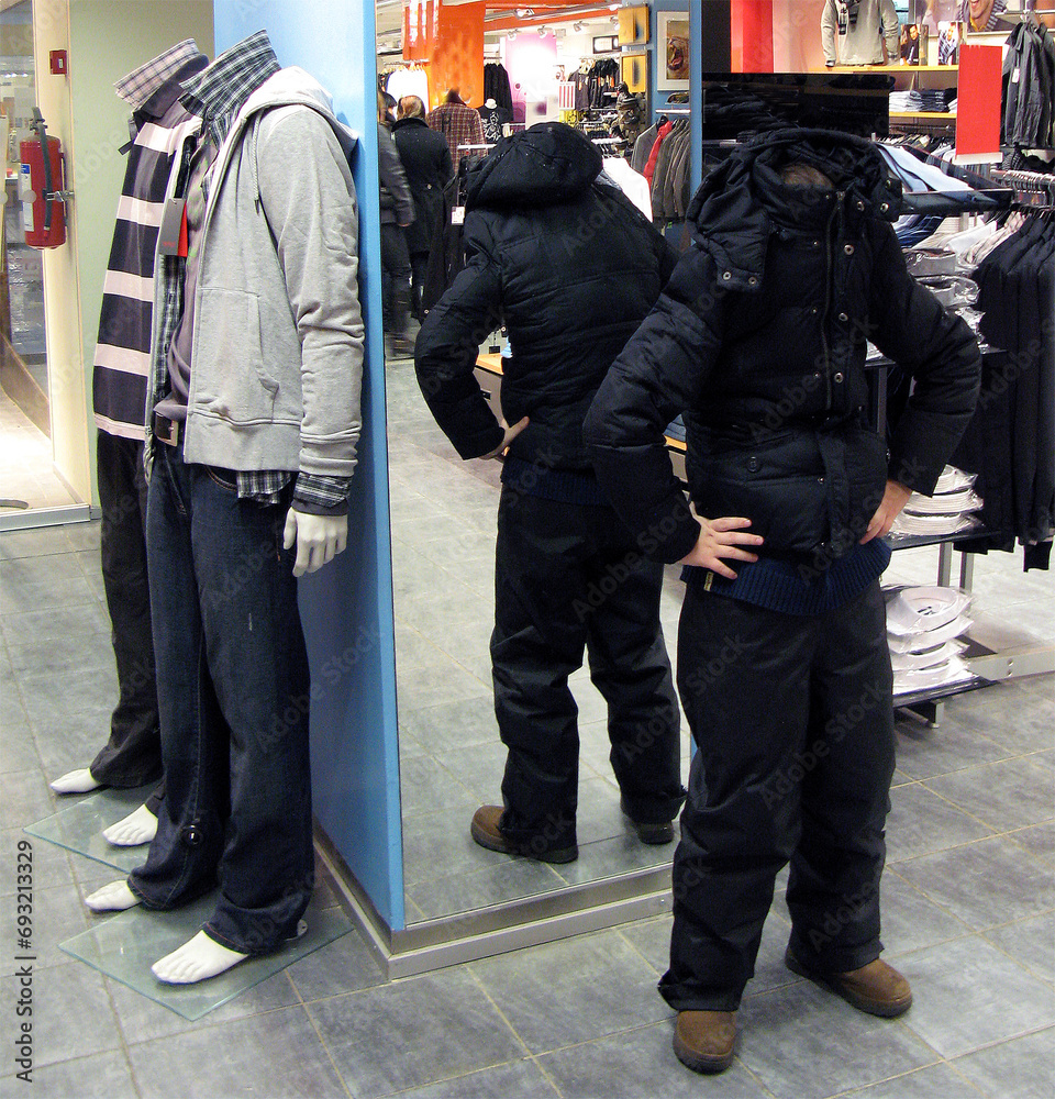 Man portrays a mannequin in a store. Man and mannequin side by side, funny situations Man portrays a mannequin in a store. Man and mannequin side by side, funny situations