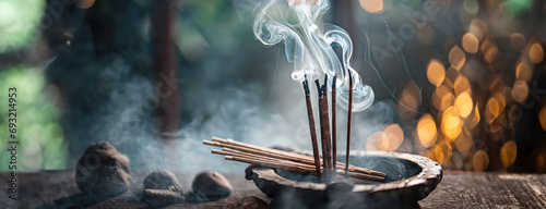 Incense sticks emit a serene smoke. Smoke from agarbatti sticks curls into a bokeh-lit background, evoking a sense of calm photo