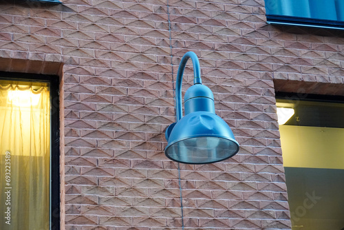 Close up of blue color lantern on red brick textured wall, Roterman city district, Tallinn, Estonia, Europe photo