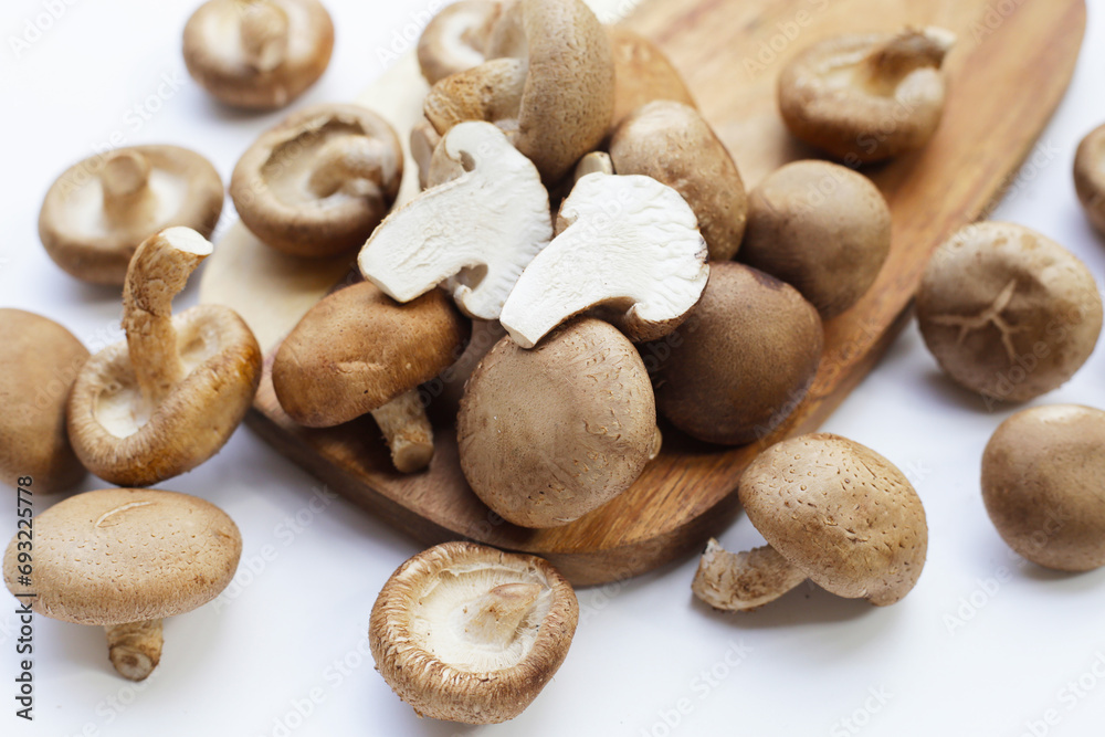 Fresh shiitake mushrooms on white background. Fresh shiitake mushrooms on white background.