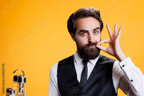 Tableau sur toile Confidential person does hush mute sign on camera, showing sealed lips gesture with hand