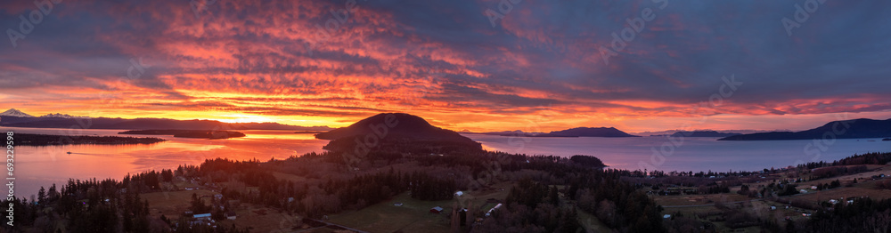 Panoramic Drone View of the South End of Lummi Island During a Spectacular Sunrise. Aerial shot of the sun rising over Bellingham Bay in the northwest corner of Washington state in the Salish Sea.