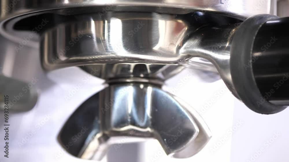Grinding fresh coffee beans with a grinder or portafilter to make hot Arabica coffee drinks in the coffee house. Macro close-up. Coffee enjoyment and Arabica consumption Grinding fresh coffee beans with a grinder or portafilter to make hot Arabica coffee drinks in the coffee house. Macro close-up. Coffee enjoyment and Arabica consumption