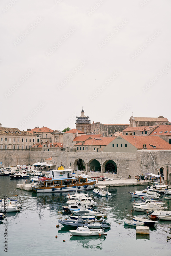 Boats are moored near the fortress walls of the old town of Dubrovnik. Croatia