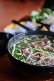 A bowl of traditional northern Vietnamese (Hanoi-style) pho tai lan: rice noodle soup with wok-fried beef and crispy garlic cooked in beef tallow at VN Street Foods in Marrickville, Sydney