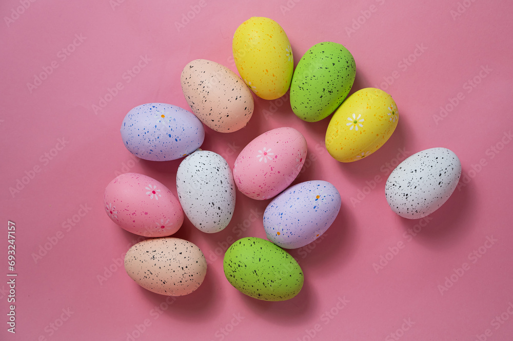 Painted quail eggs on a pink background. Easter decorations. 