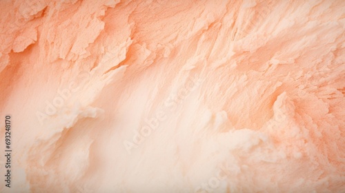 A captivating closeup of a Peach Fuzz colour backdrop with a delicate, powdery surface and a gentle blend of peach and cream hues. photo