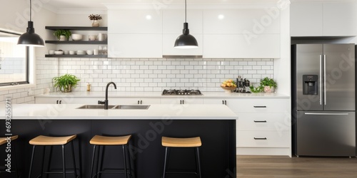 Contemporary kitchen with black and white design and subway tile splashback. photo
