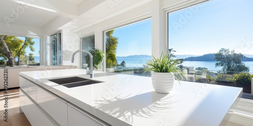 Stunning modern white Kitchen with Island and view window. © Lasvu
