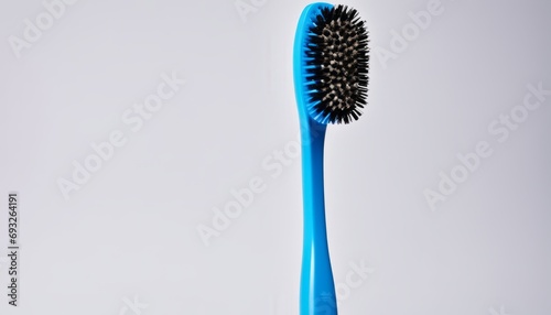 A blue toothbrush with a black brush