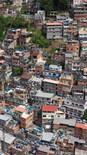 Cantagalo and Pavao-Pavaozinho Favelas. Rio de Janeiro, Brazil. Aerial View. Drone Flies Backwards and Upwards. Vertical Video