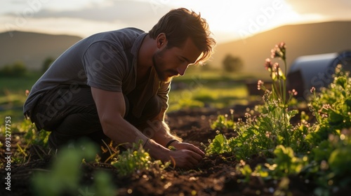 portrait of young man in vegetable garden working outside with land photo